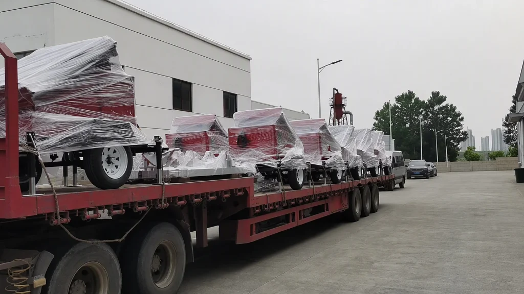 Fleet of Yuji heavy-duty mobile lighting towers lined up in factory yard after pre-shipment testing